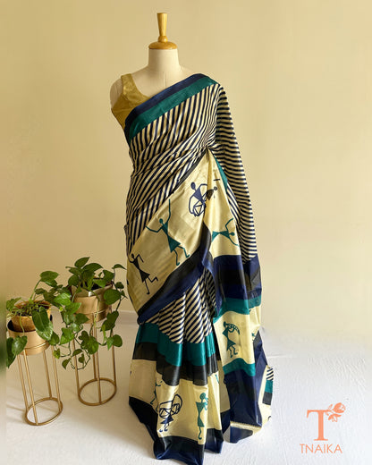 Satin silk saree with tribal-inspired prints, striped design, and bold navy teal border detailing
