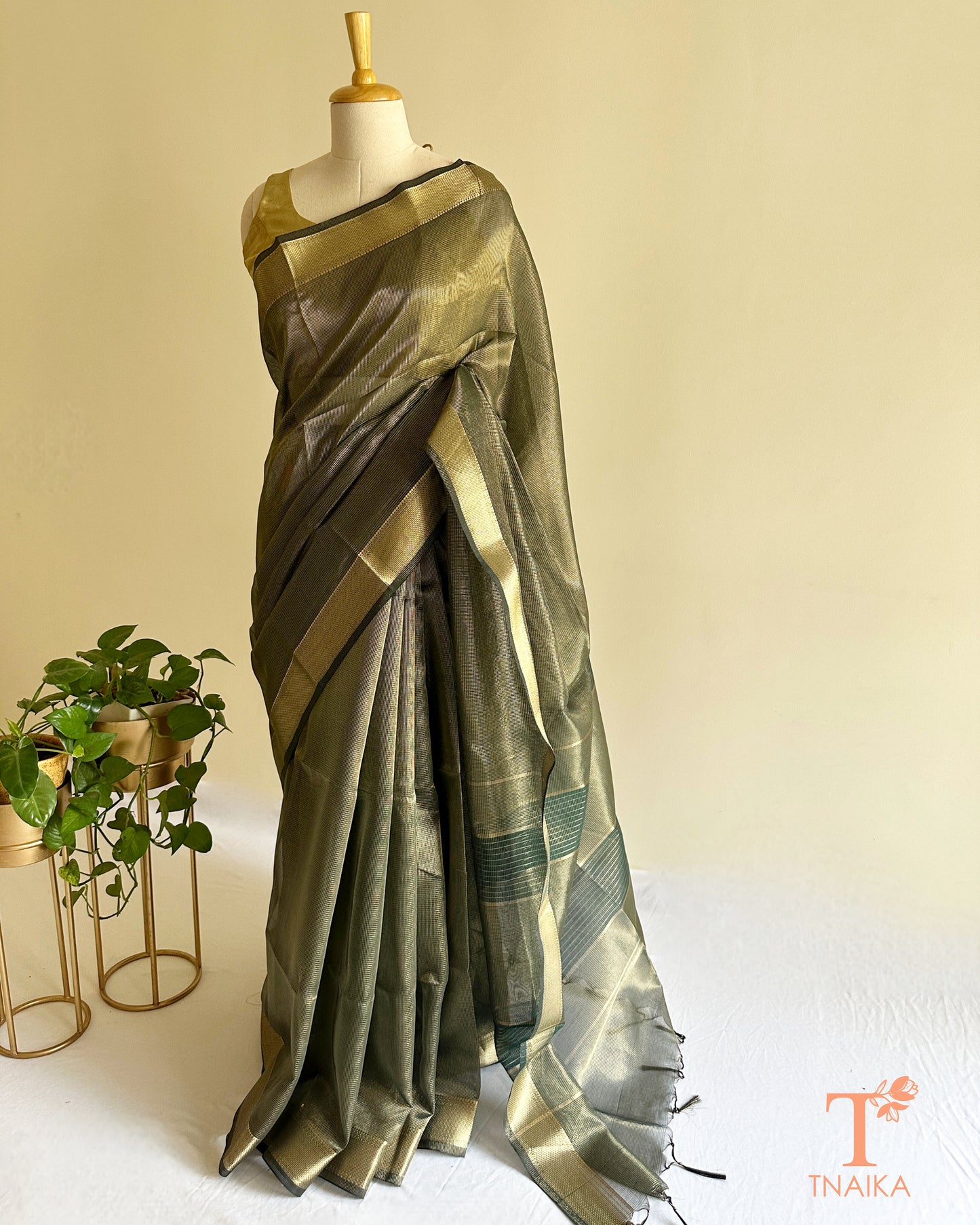 Lightweight muted green tissue silk saree with soft shimmer and traditional woven zari detailing