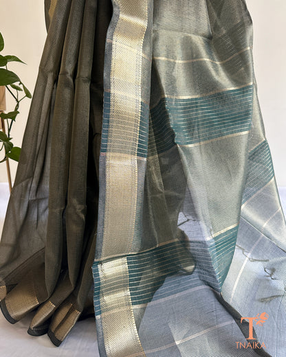 Lightweight muted green tissue silk saree with soft shimmer and traditional woven zari detailing