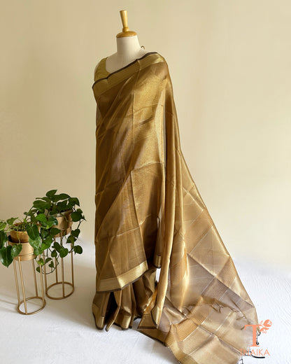 Close-up of bronze tissue silk saree showcasing fine checks texture, golden zari detailing, and graceful festive finish
