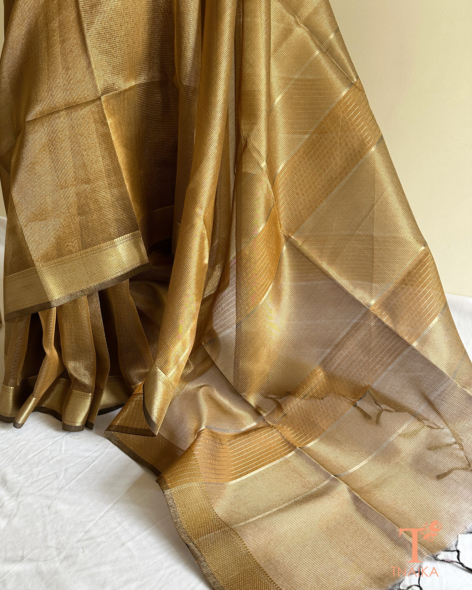 Elegant muted brown gold tissue silk saree with airy translucent drape and rich zari woven border
