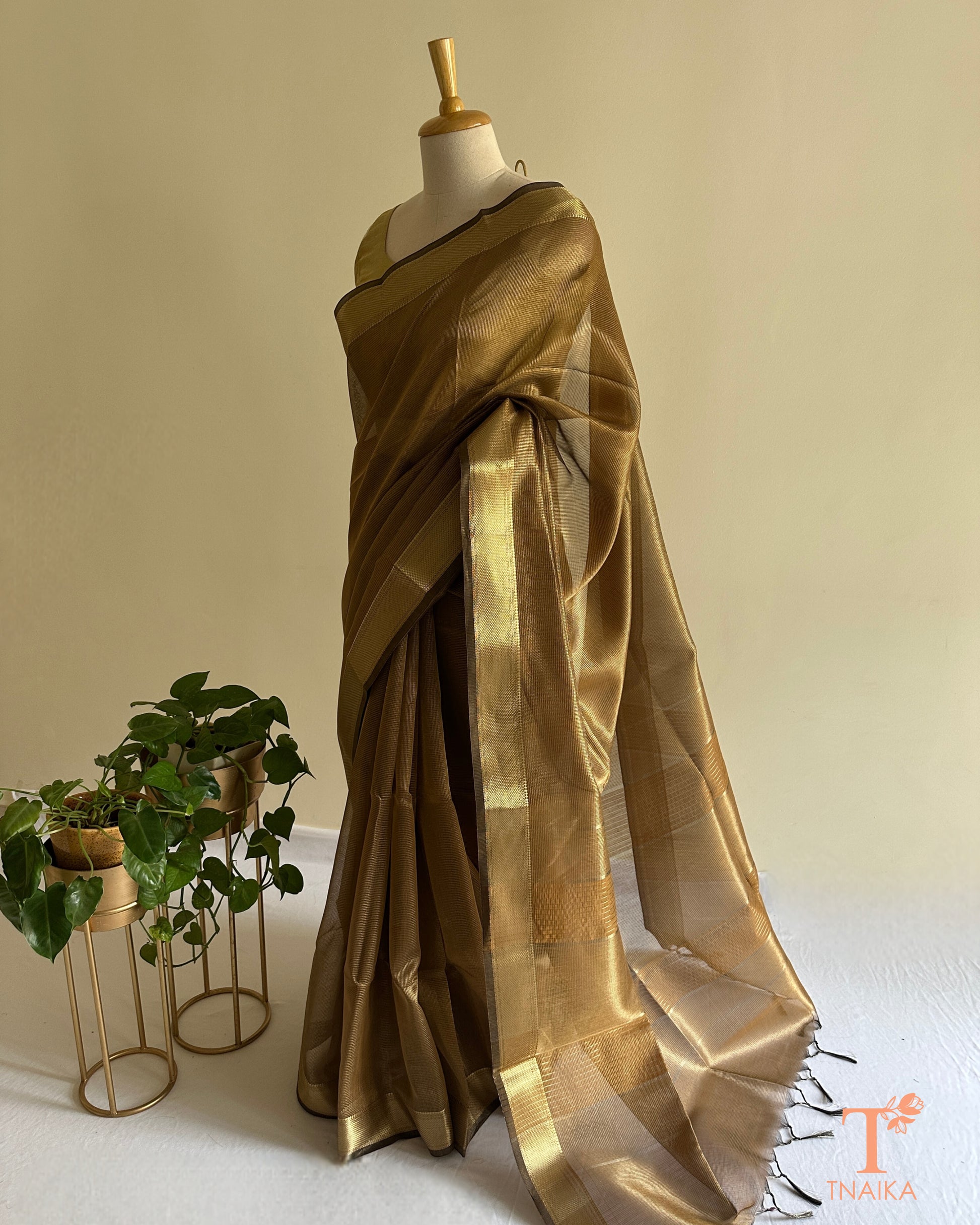 Lightweight bronze tissue silk checks saree featuring luminous sheen, delicate micro-check weave, and tassel pallu accents