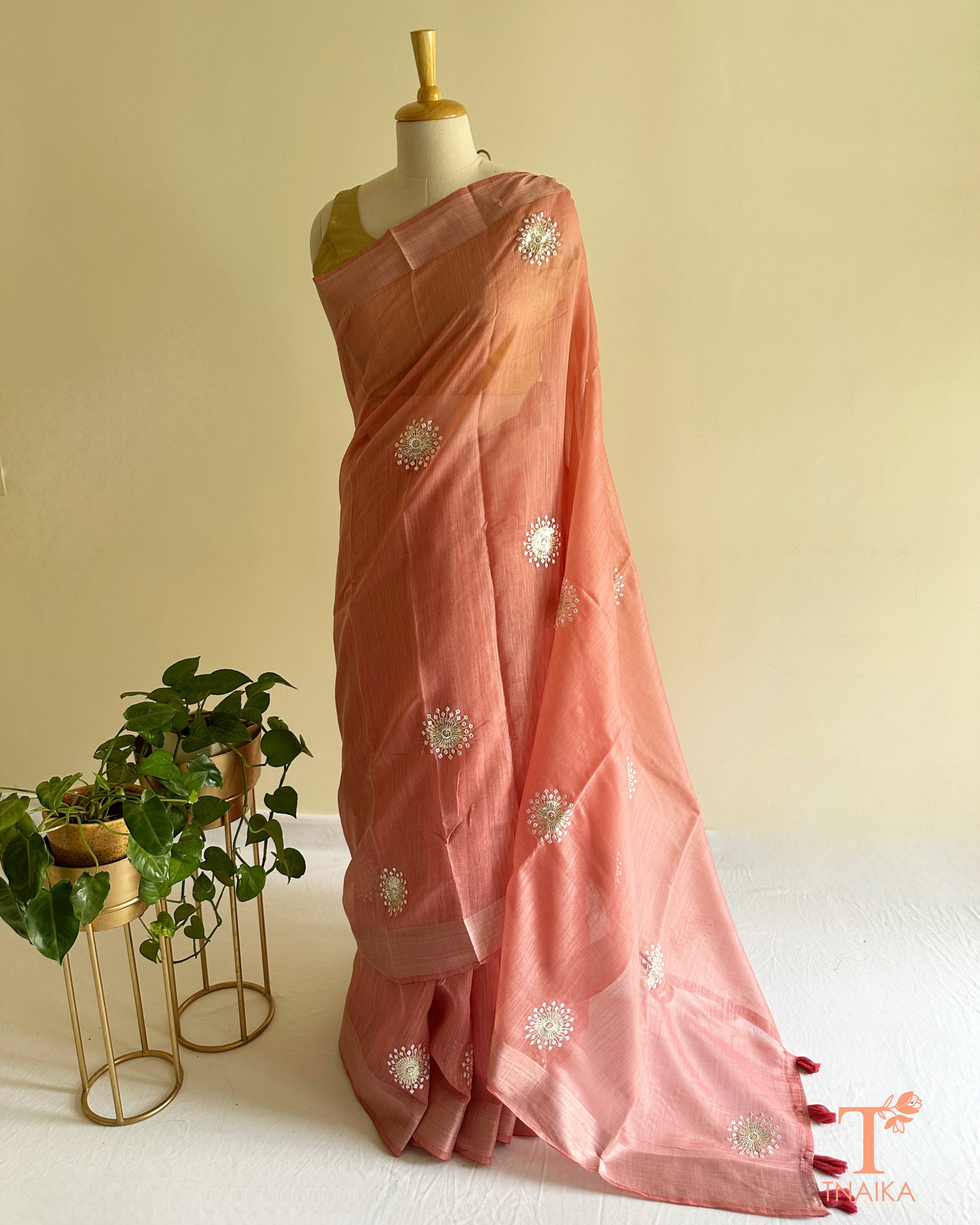 Blush pink cotton saree with delicate embroidered floral butti motifs and soft elegant drape
