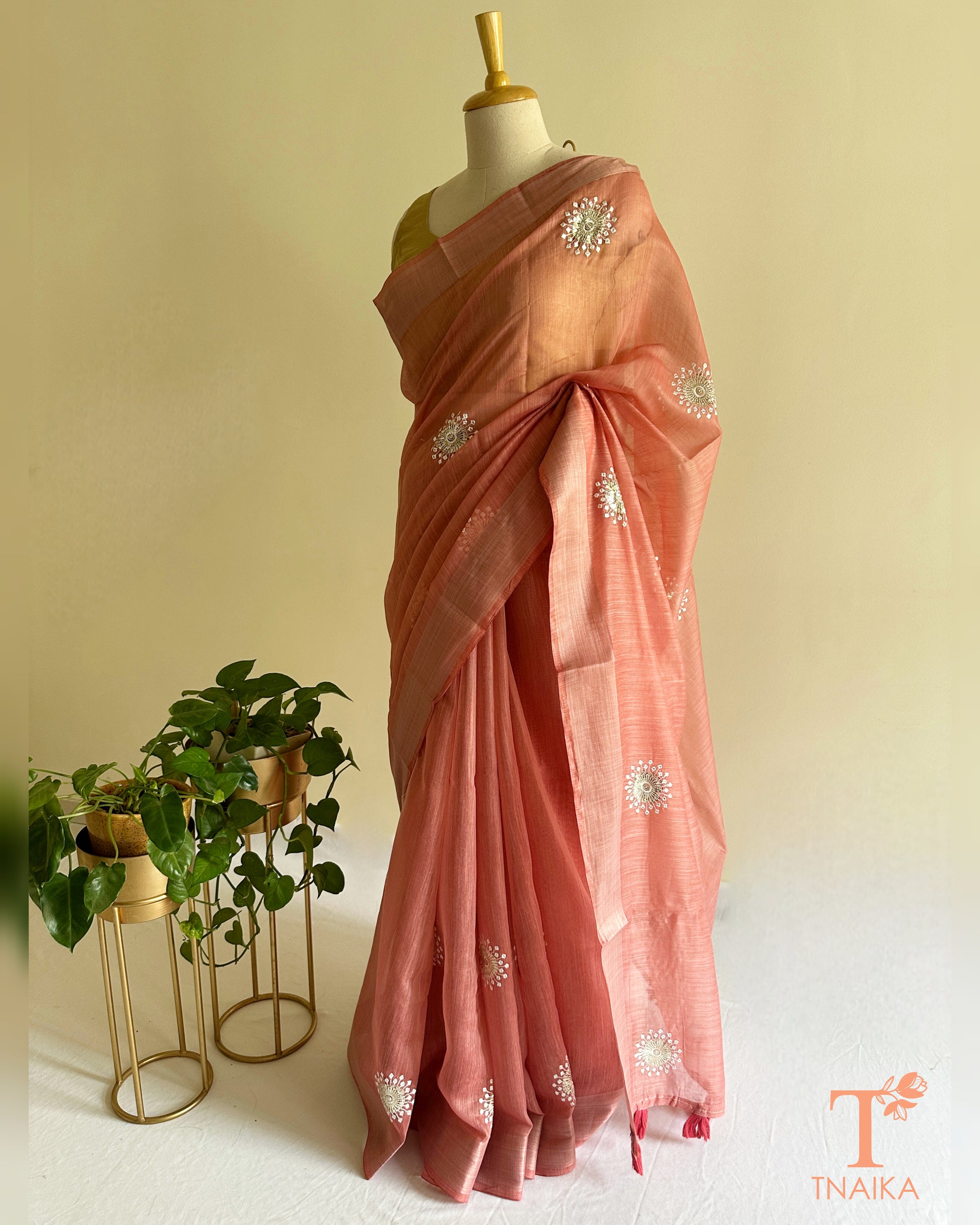 Elegant embroidered cotton saree in soft pink shade with breathable texture and festive charm