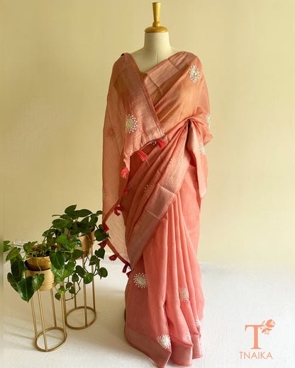 Minimal blush pink cotton saree with handcrafted embroidery and soft fluid festive drape
