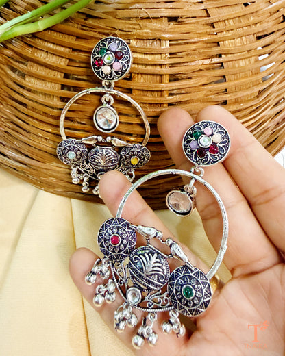 Oxidised silver tone earrings with multicolor stone work and intricate ethnic detailing.