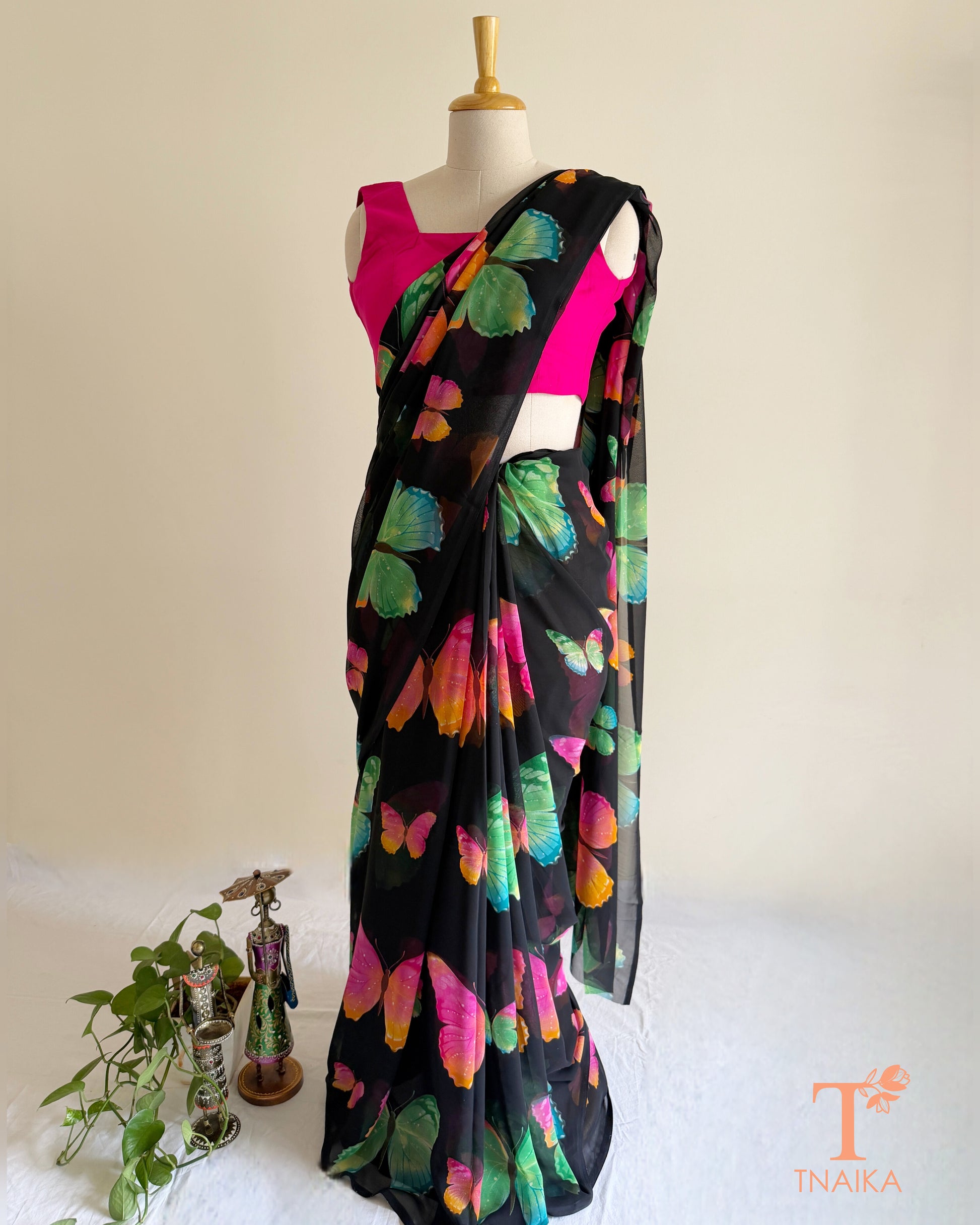 Black saree featuring vibrant pink, blue and green butterflies