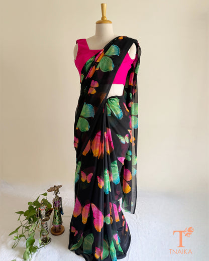 Black saree featuring vibrant pink, blue and green butterflies