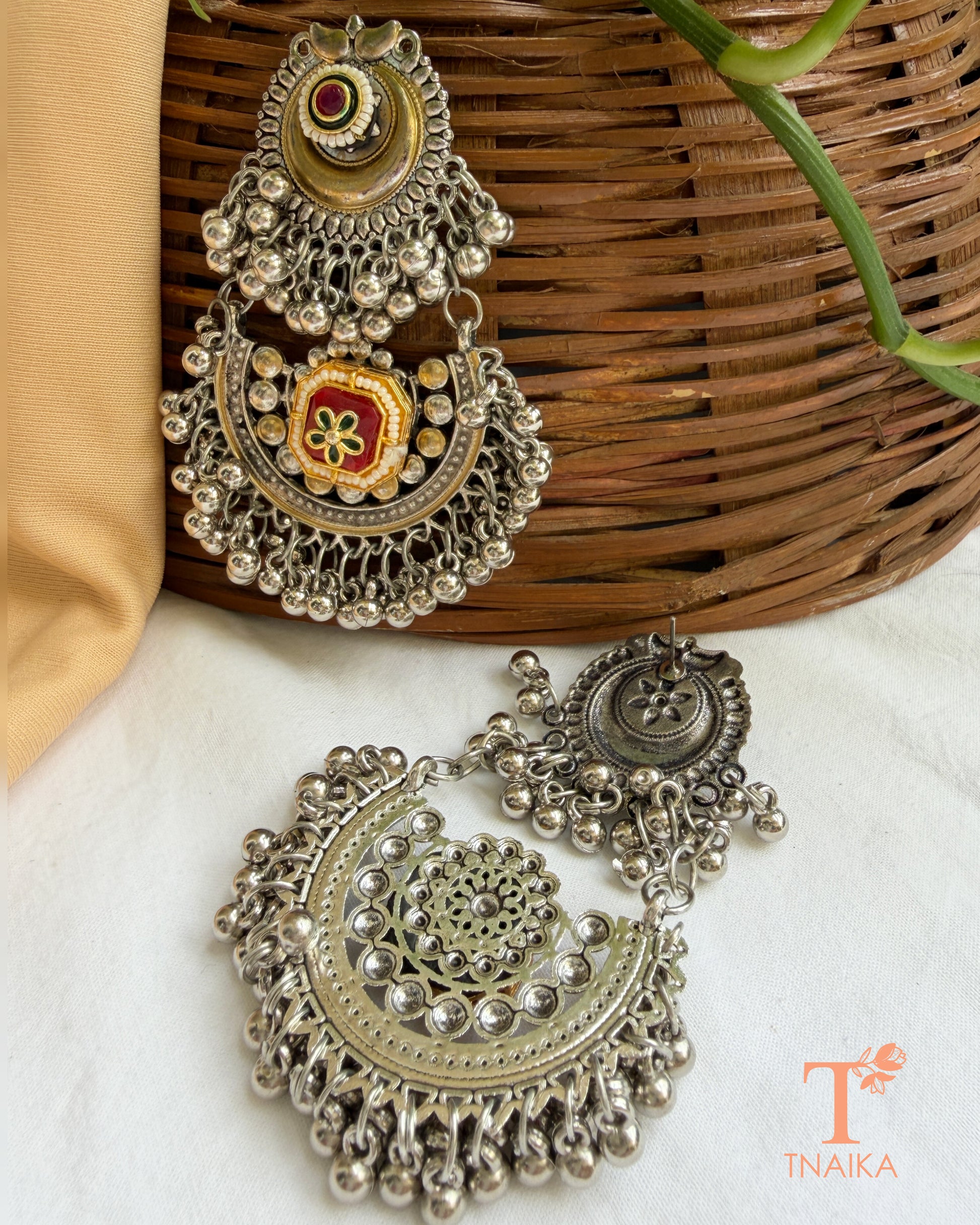 Ethnic chandbali earrings with pearl accents and intricate meena work.