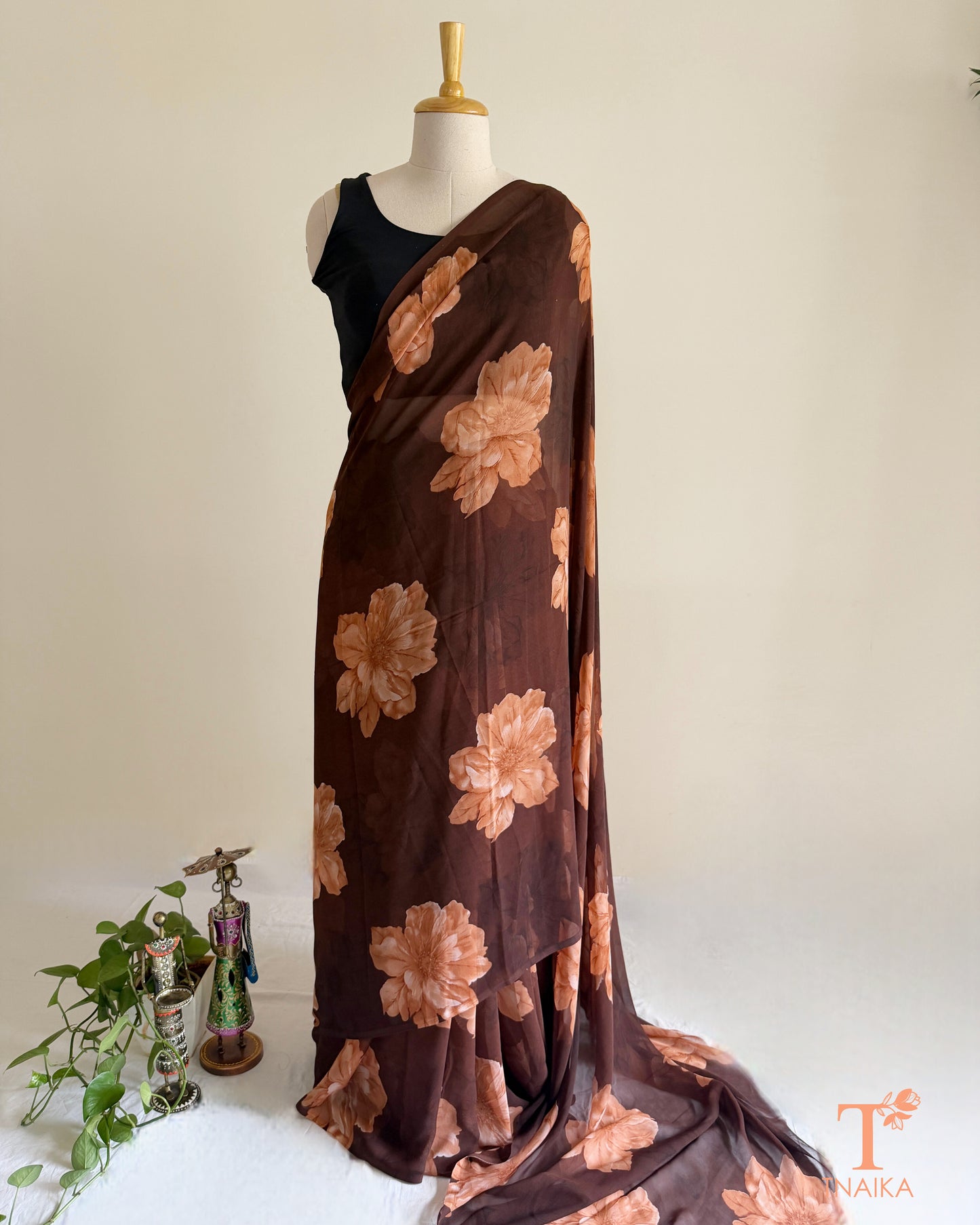 Brown georgette saree with large pink floral prints