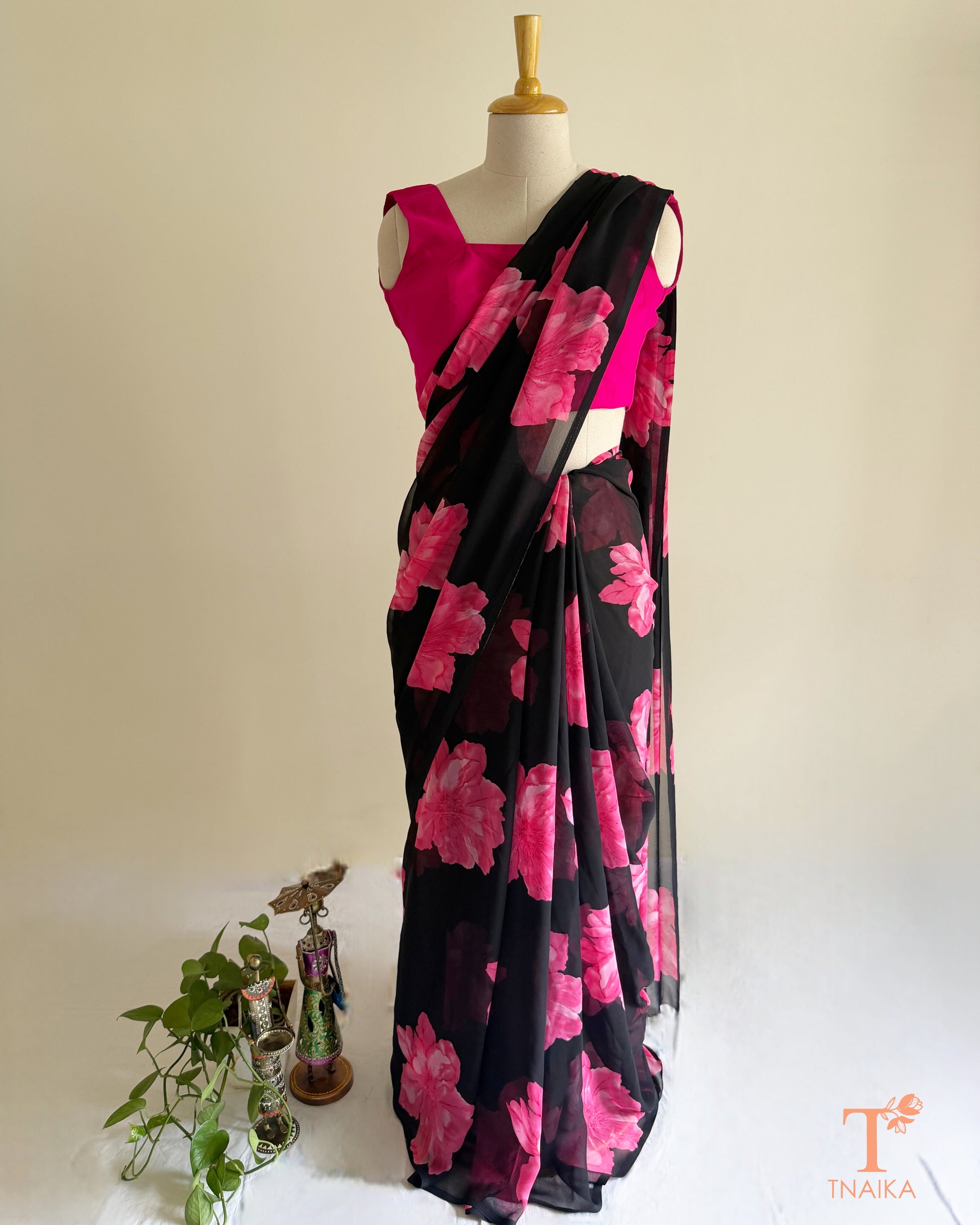 Black georgette saree with large pink floral prints