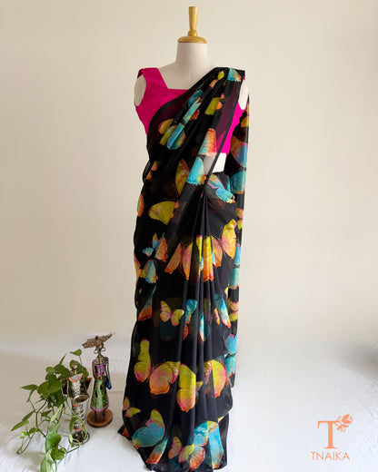 Black saree featuring vibrant pink, blue and green butterflies