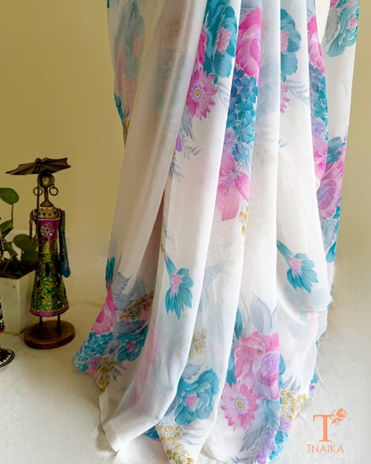 White saree adorned with blooming multicolor flowers