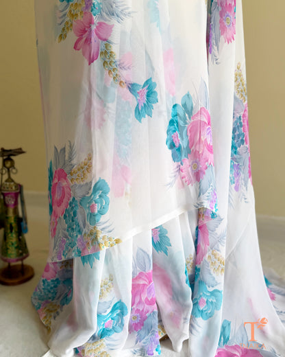 Lightweight white georgette saree featuring floral patterns