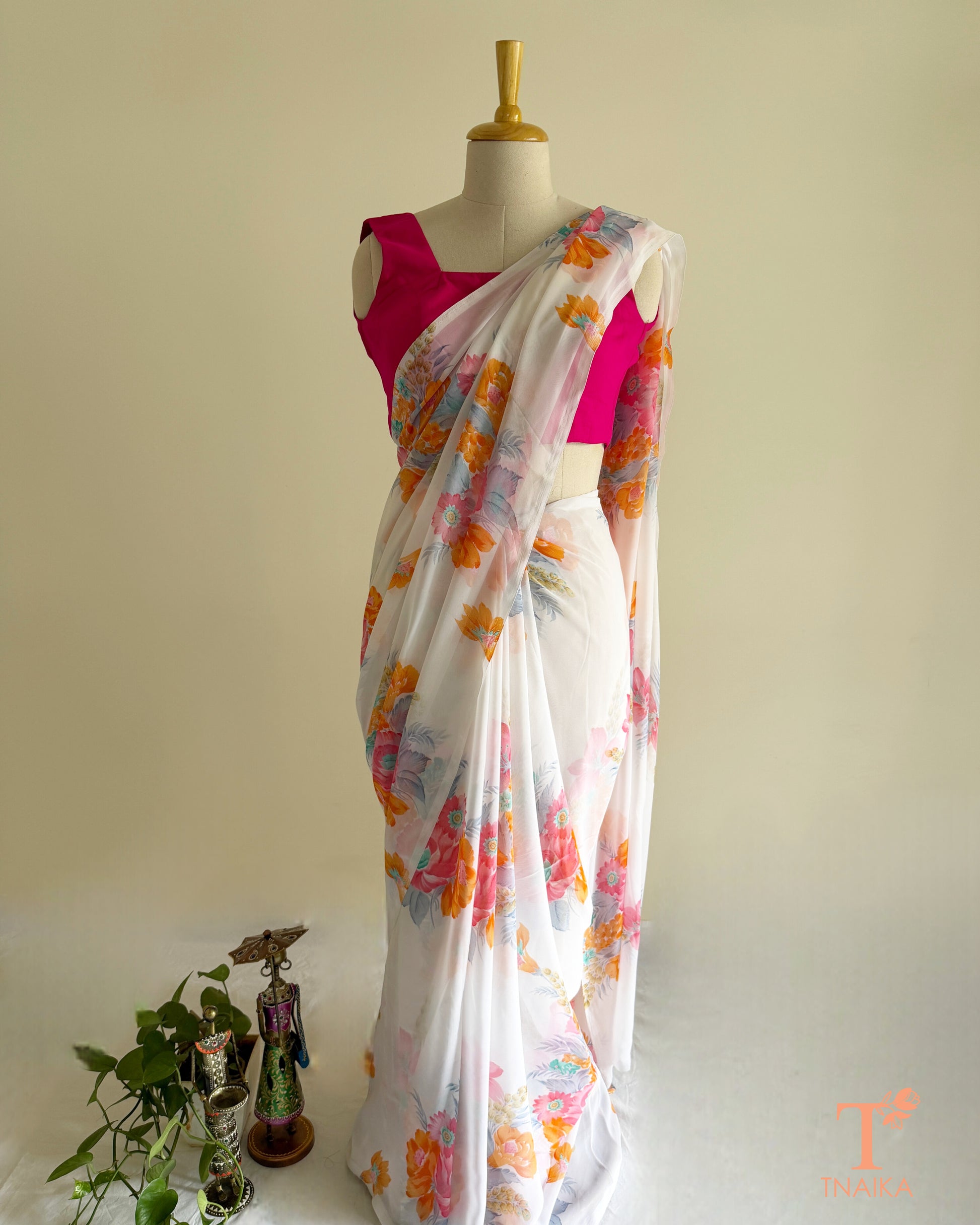 Lightweight white georgette saree featuring floral patterns