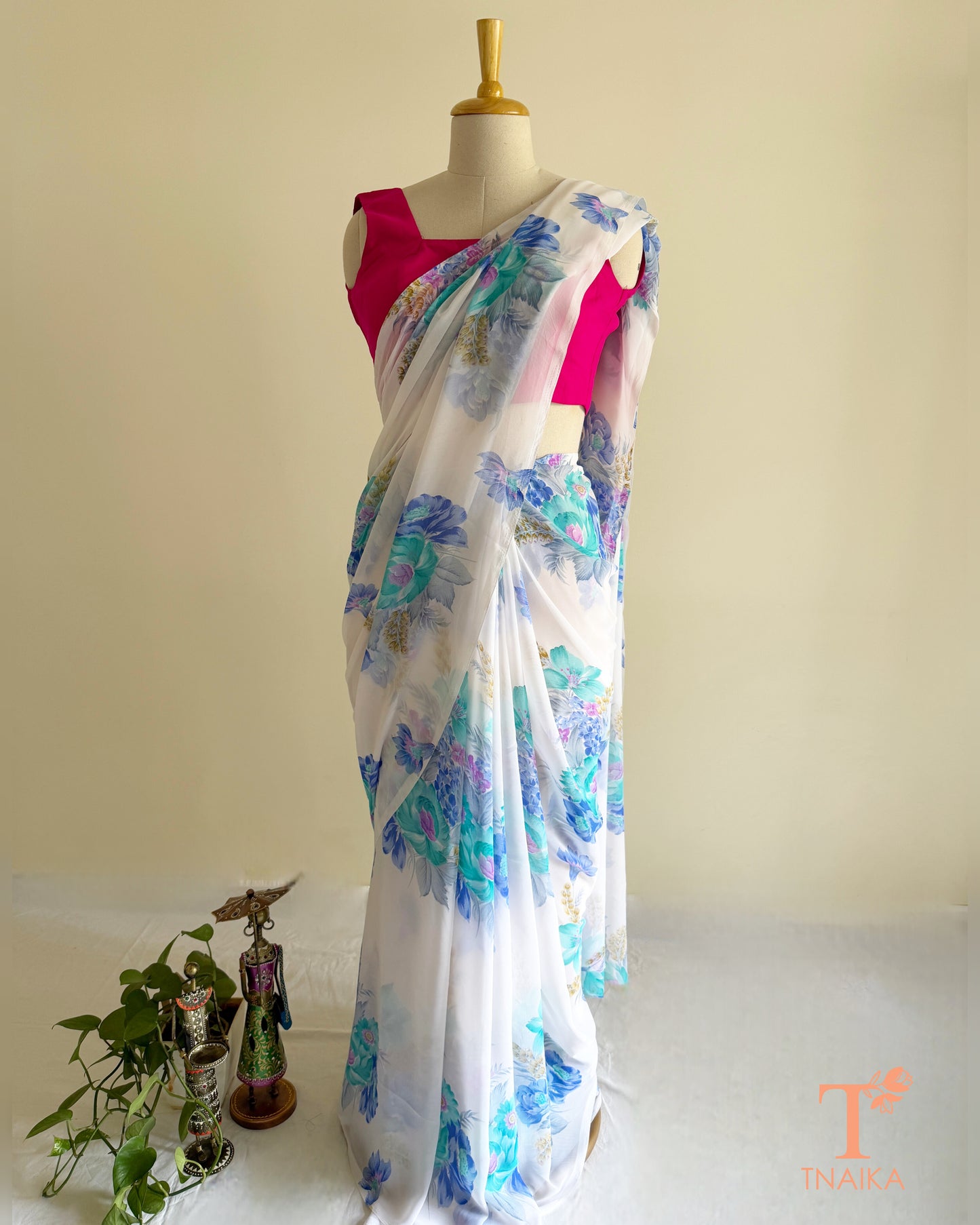 Lightweight white georgette saree featuring floral patterns
