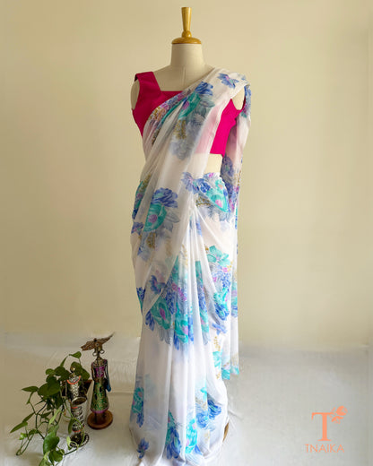 Lightweight white georgette saree featuring floral patterns