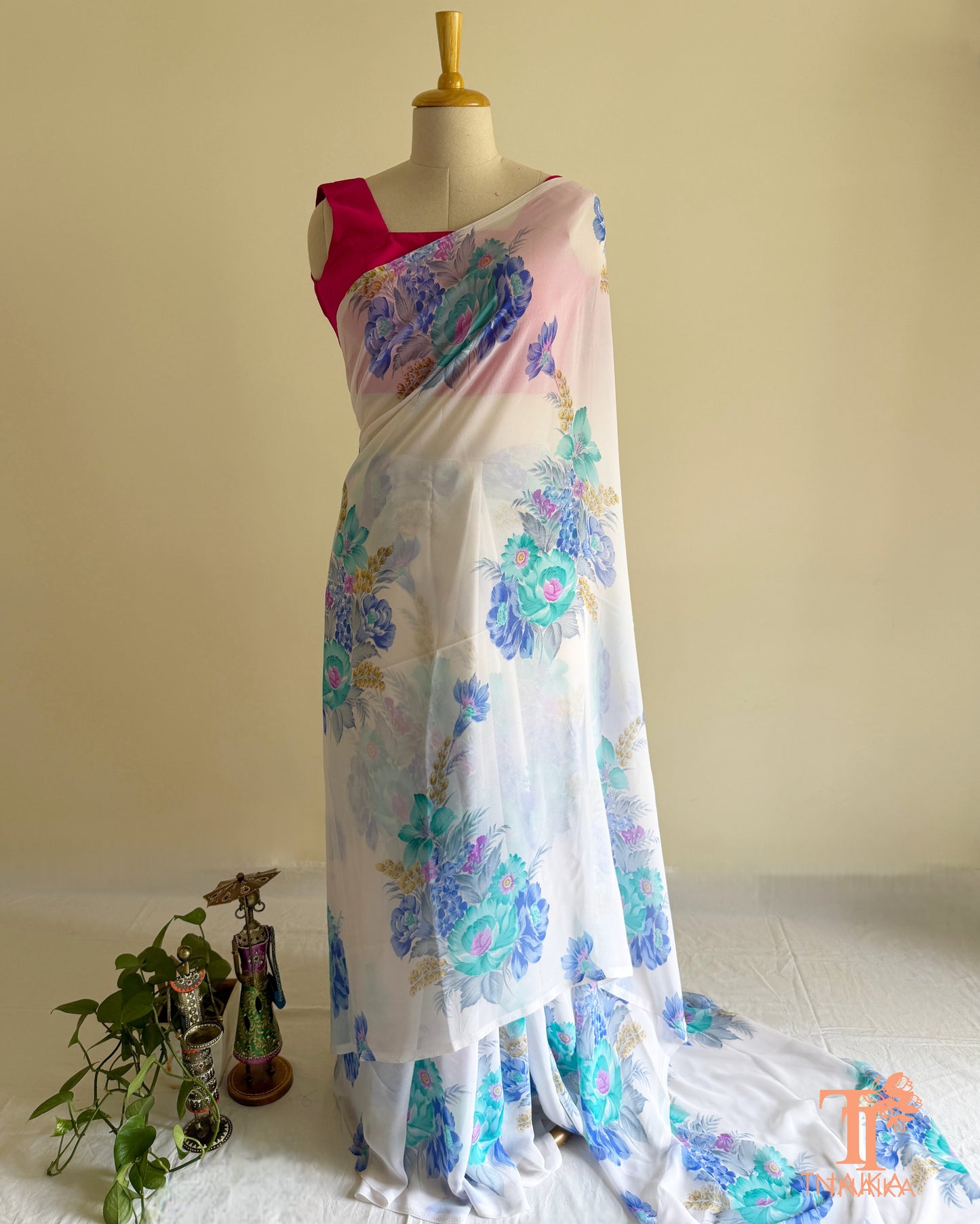 White saree adorned with blooming multicolor flowers
