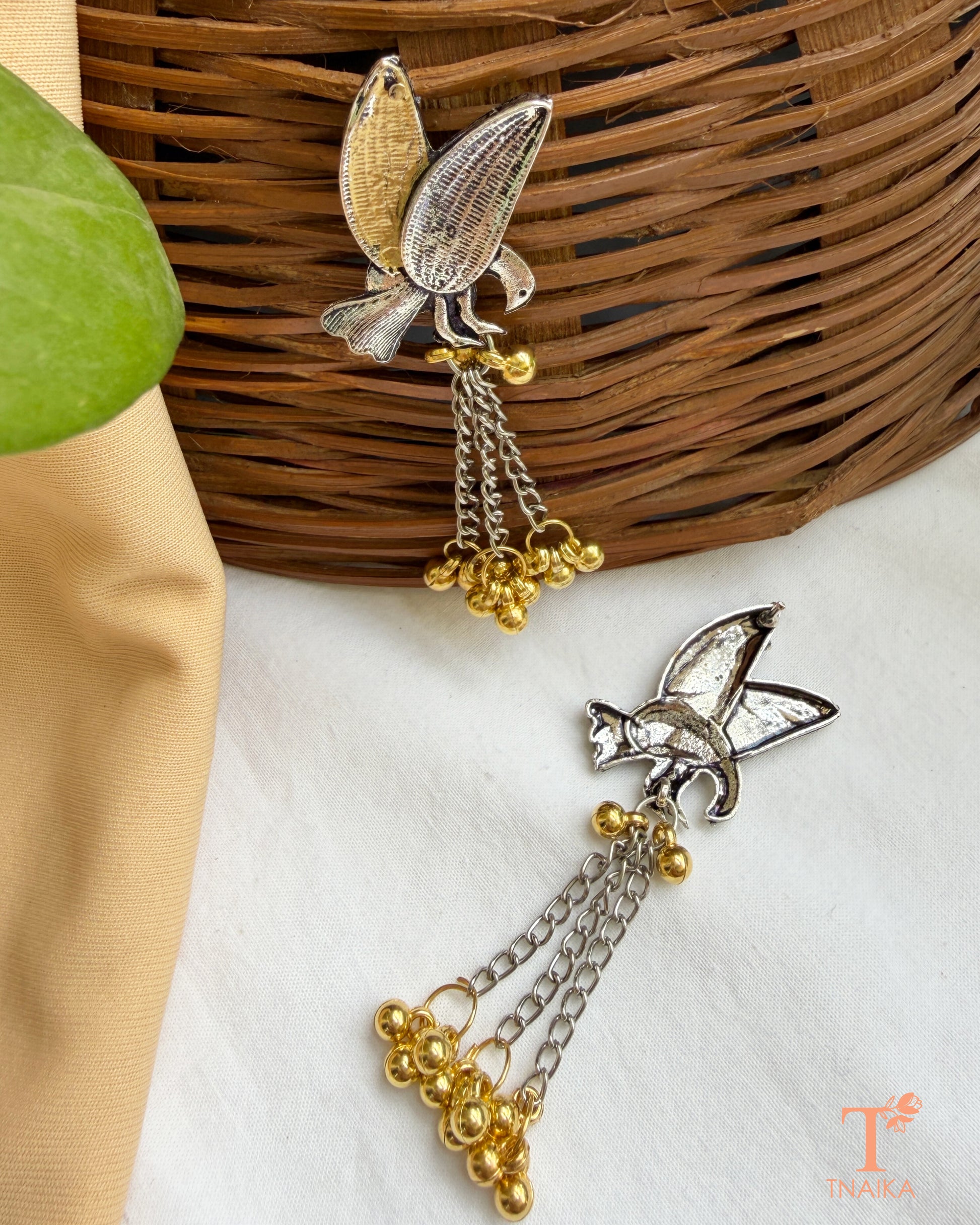 Dual tone bird earrings with chain tassels and decorative ghungroo drops.