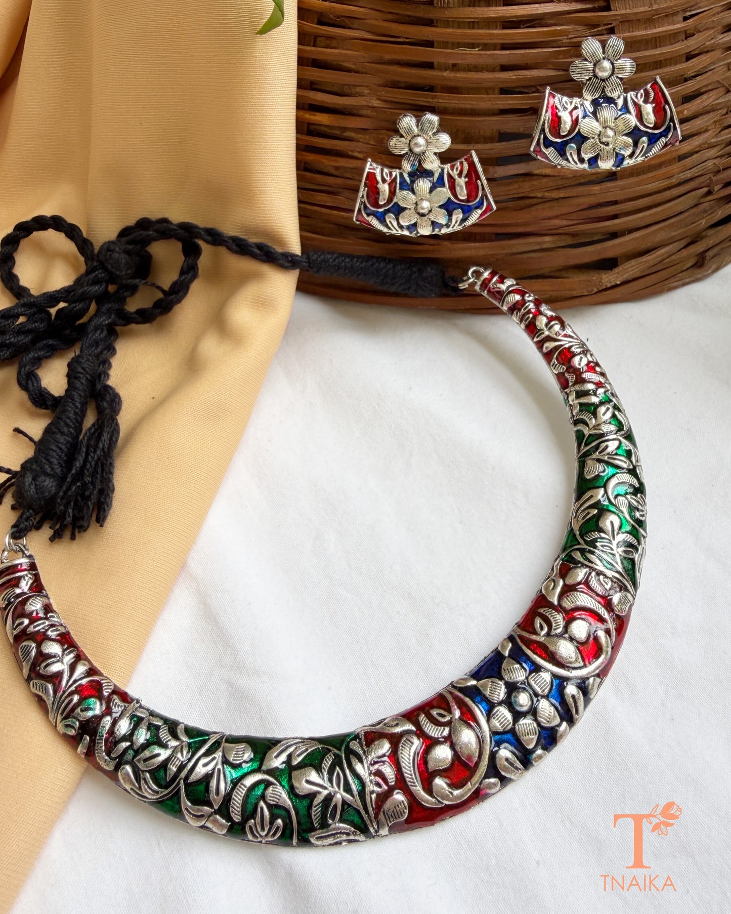 Oxidised meena work hasli choker necklace with matching floral stud earrings.