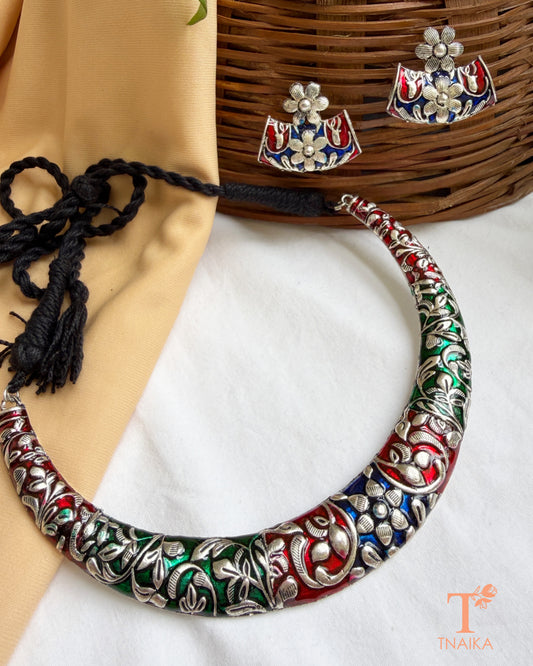Oxidised meena work hasli choker necklace with matching floral stud earrings.