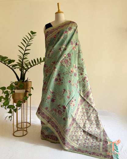 Elegant linen cotton saree featuring mauve floral motifs and decorative tassels.