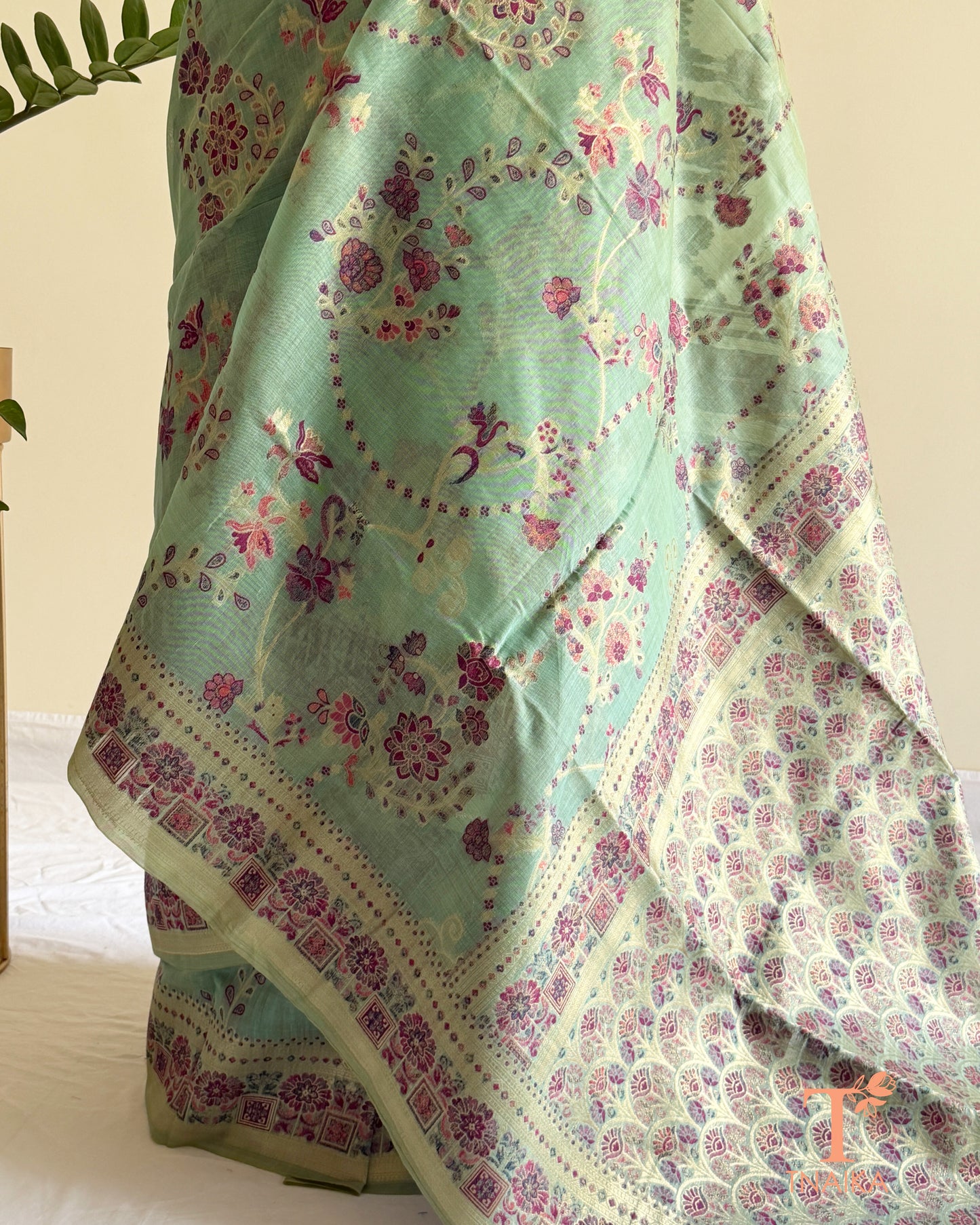 Lightweight mint linen cotton saree with intricate printed pallu and border.