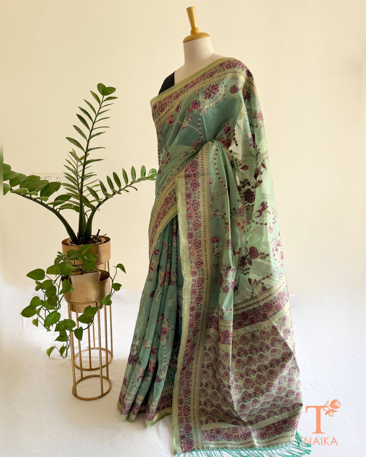 Mint green linen cotton saree with heritage floral print and detailed border.