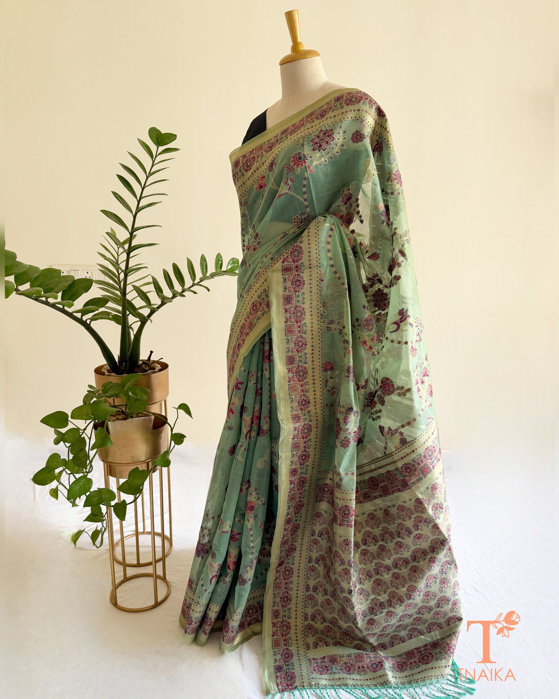 Mint green linen cotton saree with heritage floral print and detailed border.