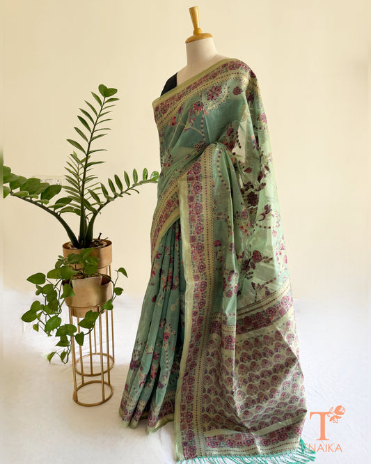 Mint green linen cotton saree with heritage floral print and detailed border.