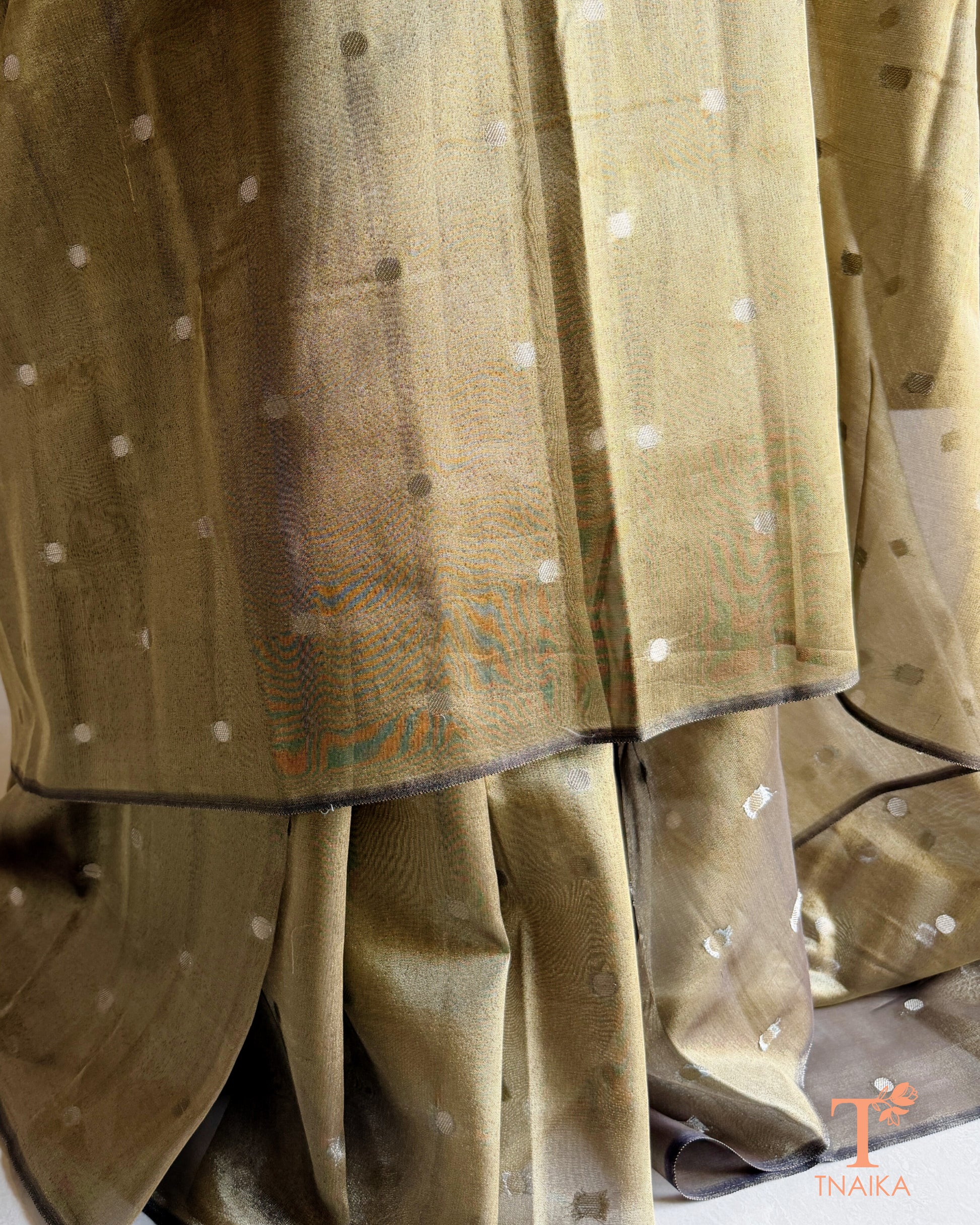 Festive tissue silk saree featuring woven silver buttas and refined metallic finish.