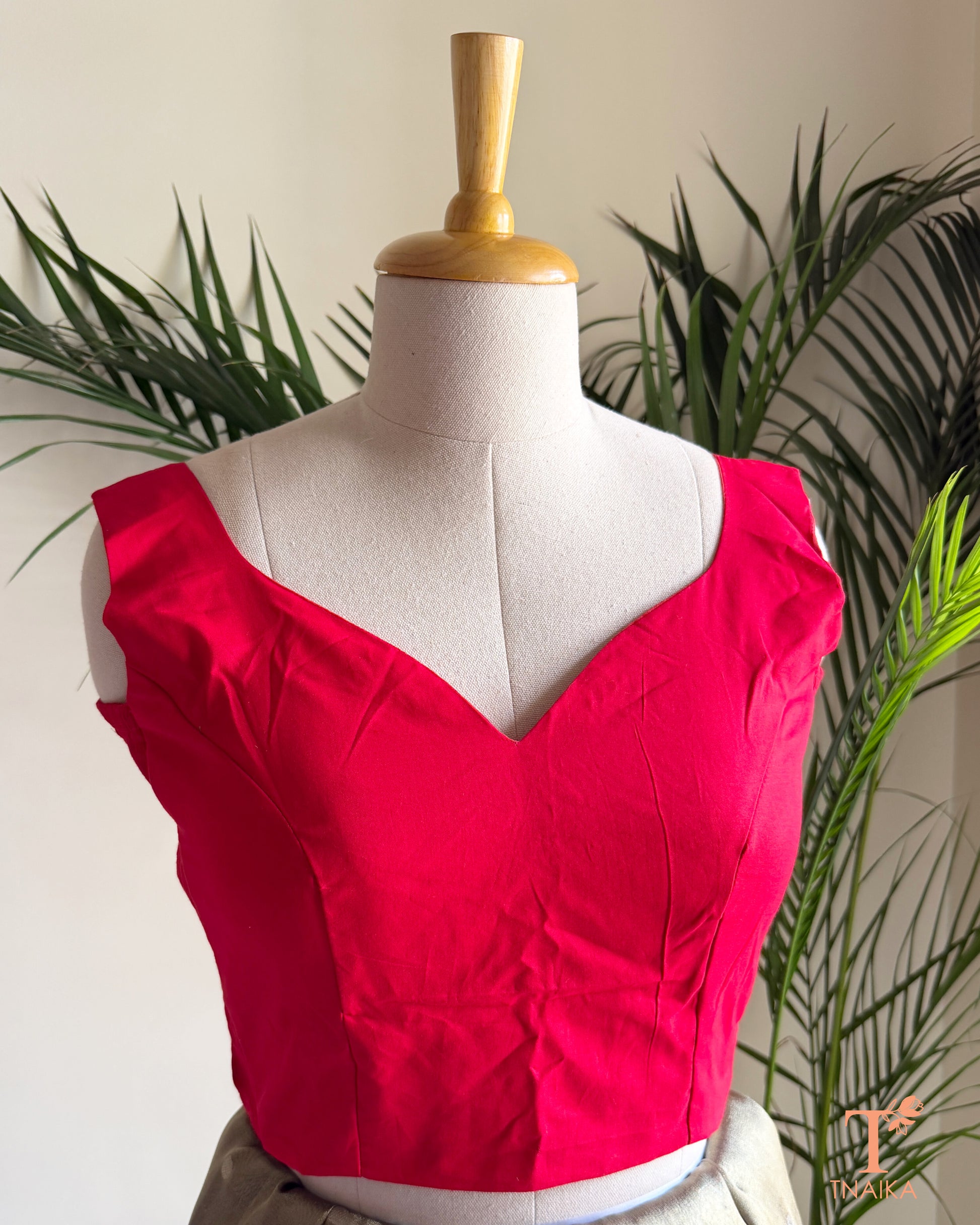 Front view of a padded cotton silk blouse with sweetheart paan shape-neckline, broad shoulder straps, and premium fit.
