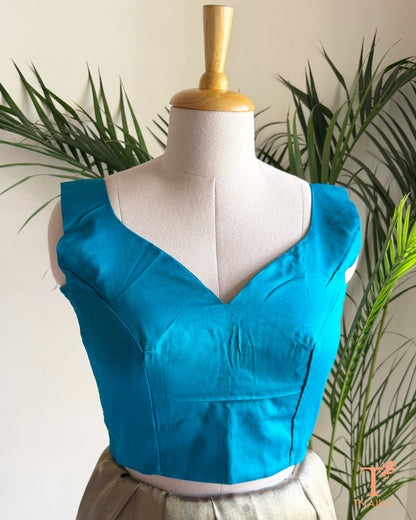 Premium cotton silk blouse featuring a sweetheart paan shape-neckline, broad shoulder straps, and a structured tailored fit for sarees.