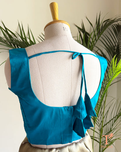 Back view of padded cotton silk blouse with deep round back, tie-up tassel detailing, and elegant silhouette.