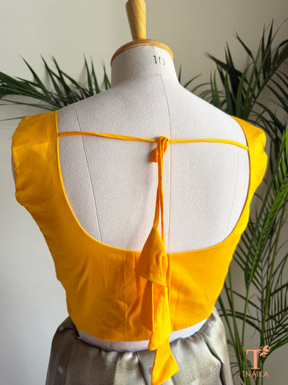 Back view of premium cotton silk blouse with deep round back, tie-up detail, padded lining, and comfortable elastic side panels.