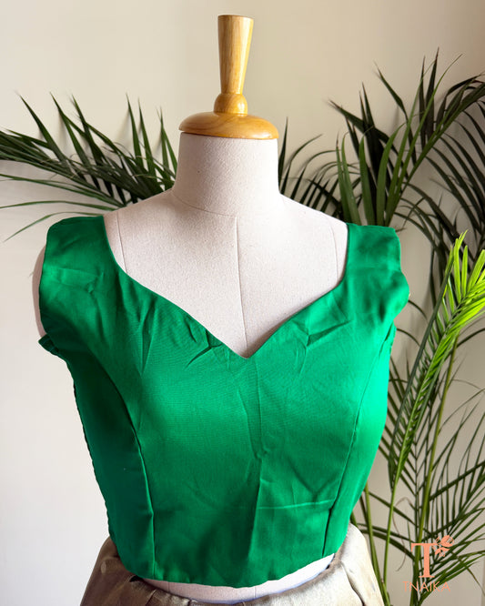 Front view of padded cotton silk blouse featuring a deep paan shape neck and structured silhouette.