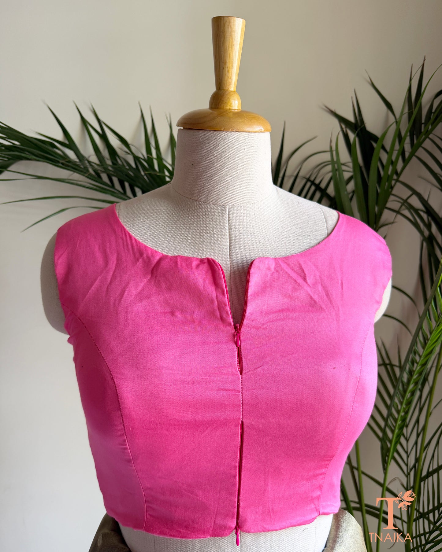Front view of sleeveless cotton silk saree blouse showcasing the innovative dual zipper opening from the top and bottom for an adjustable fit.