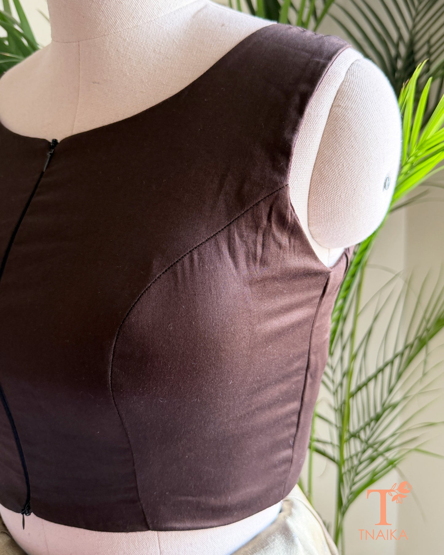 Side profile of the silk blend blouse highlighting the flattering princess-cut tailoring and structured silhouette.