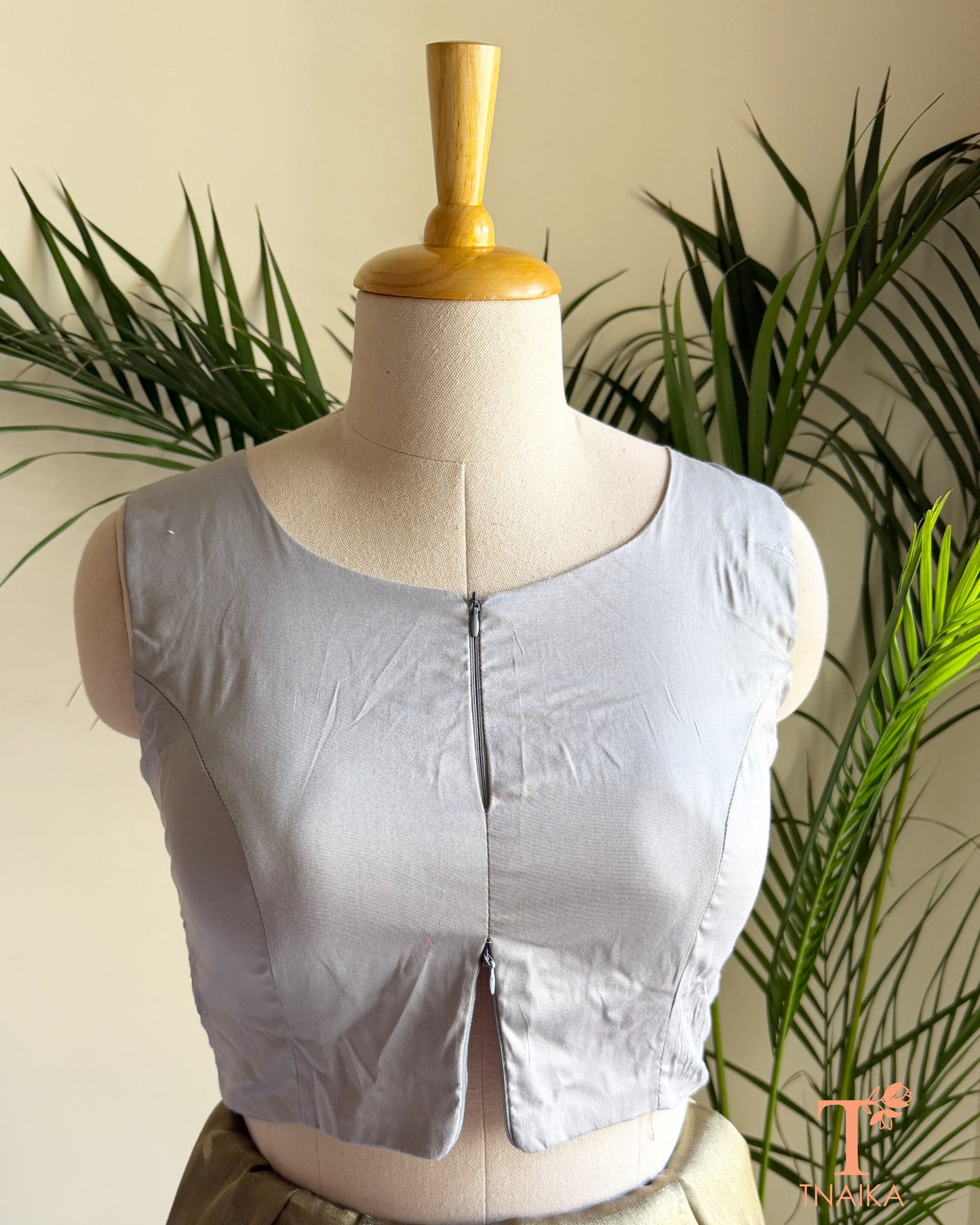 Front view of sleeveless cotton silk saree blouse showcasing the innovative dual zipper opening from the top and bottom for an adjustable fit.