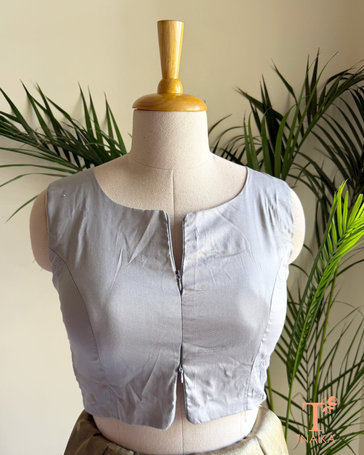 Cotton Silk sleeveless blouse featuring a modern notched round neckline and adjustable dual front zipper.