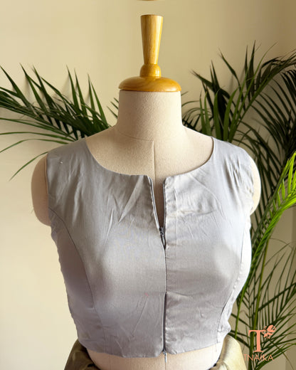 Front view of sleeveless cotton silk saree blouse showcasing the innovative dual zipper opening from the top and bottom for an adjustable fit.