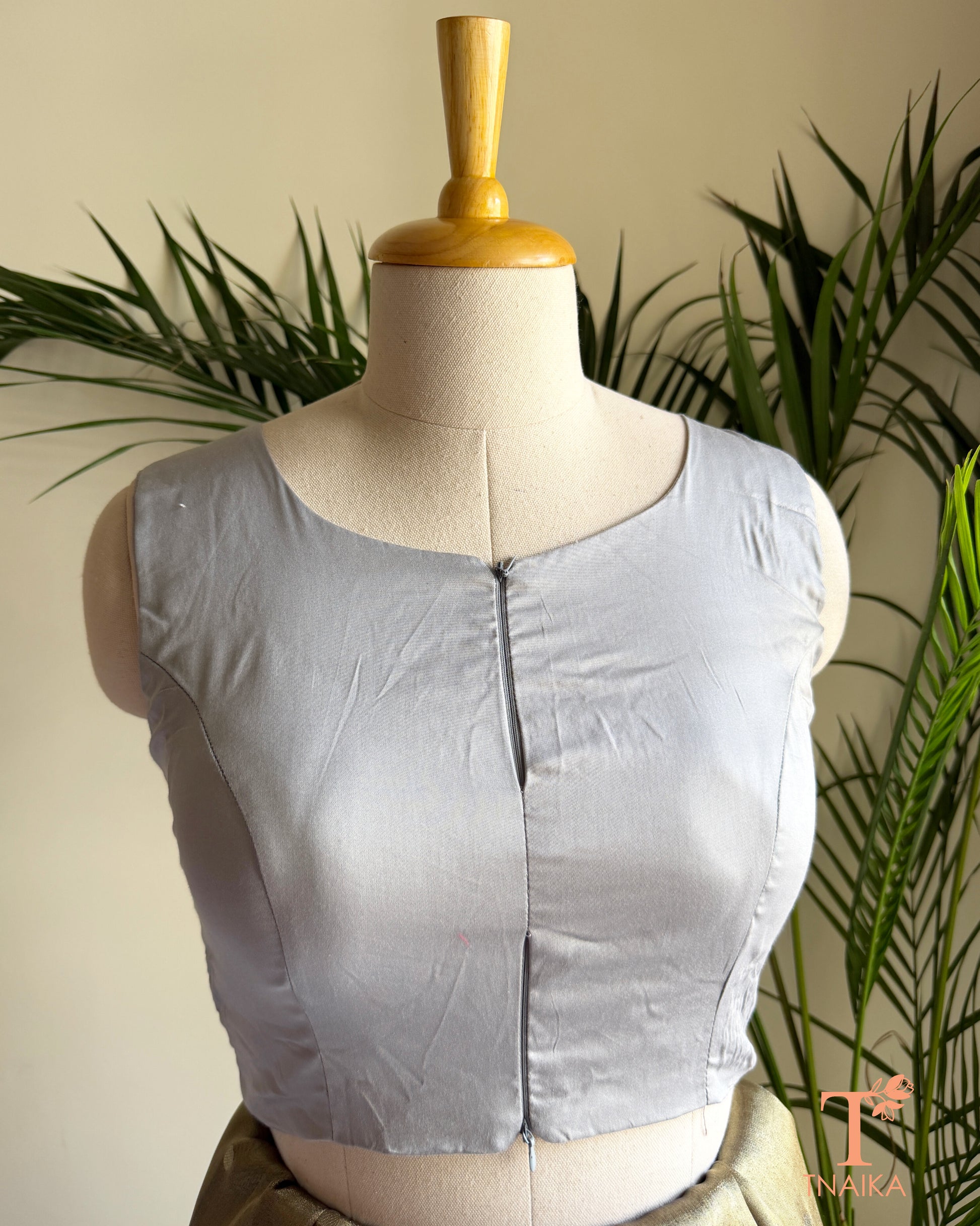 Close-up of the contemporary notched neckline and dual front zip detail .