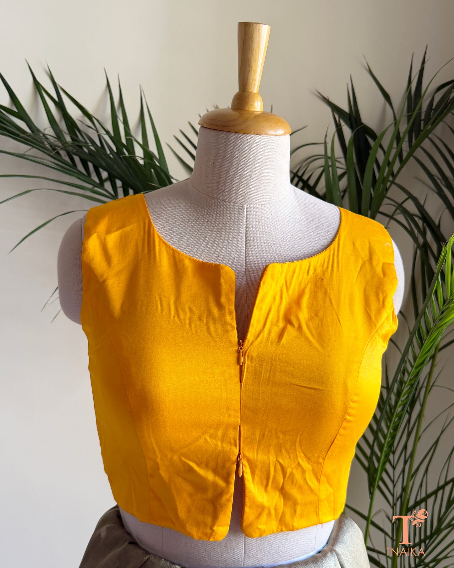 Cotton Silk sleeveless blouse featuring a modern notched round neckline and adjustable dual front zipper.