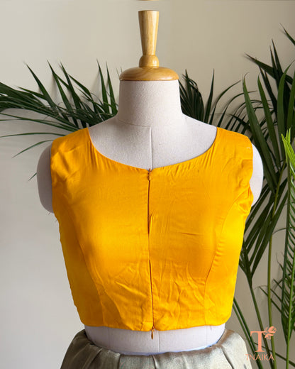 Close-up of the contemporary notched neckline and dual front zip detail on the premium emerald green blouse.