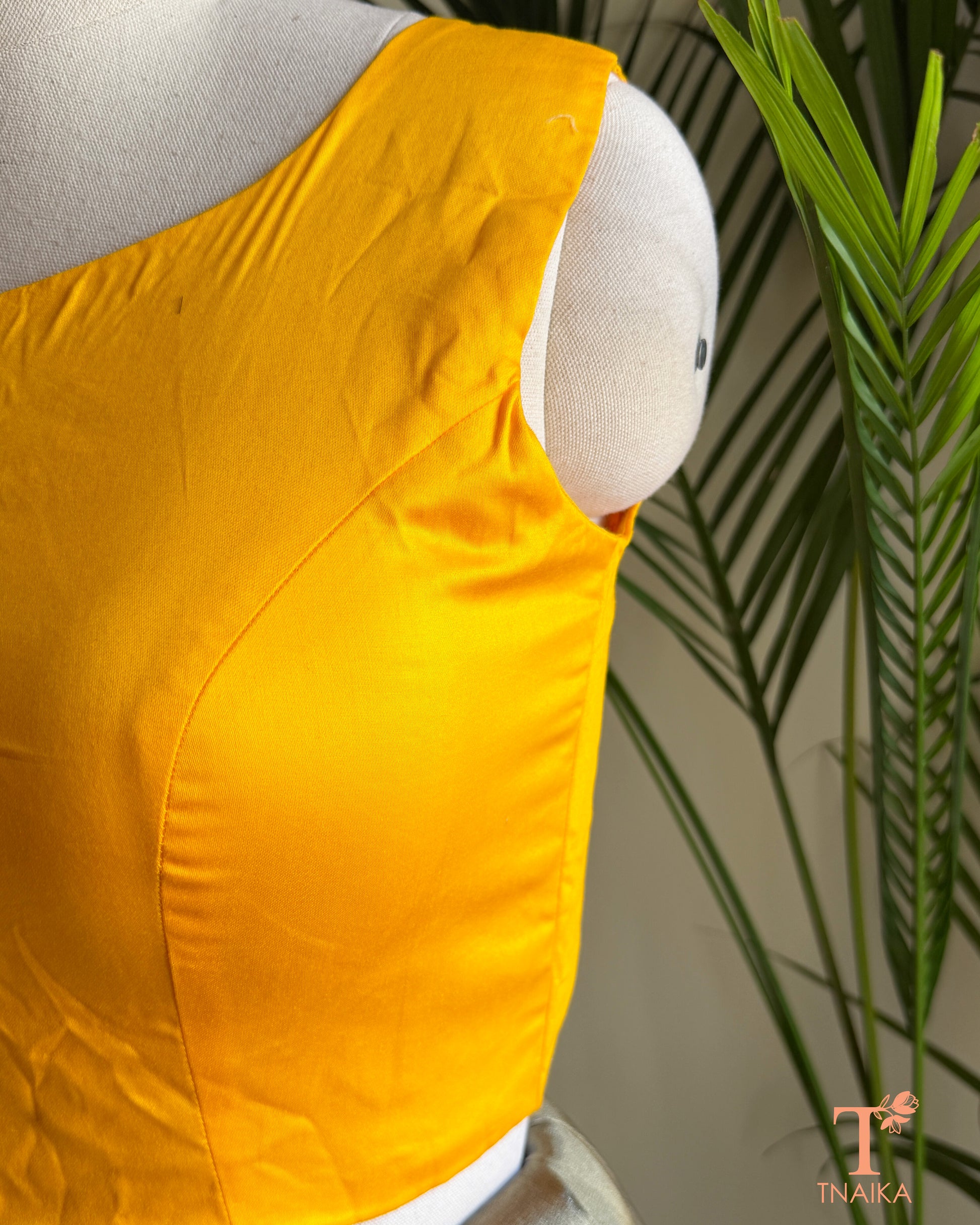 Side profile of the silk blend blouse highlighting the flattering princess-cut tailoring and structured silhouette.