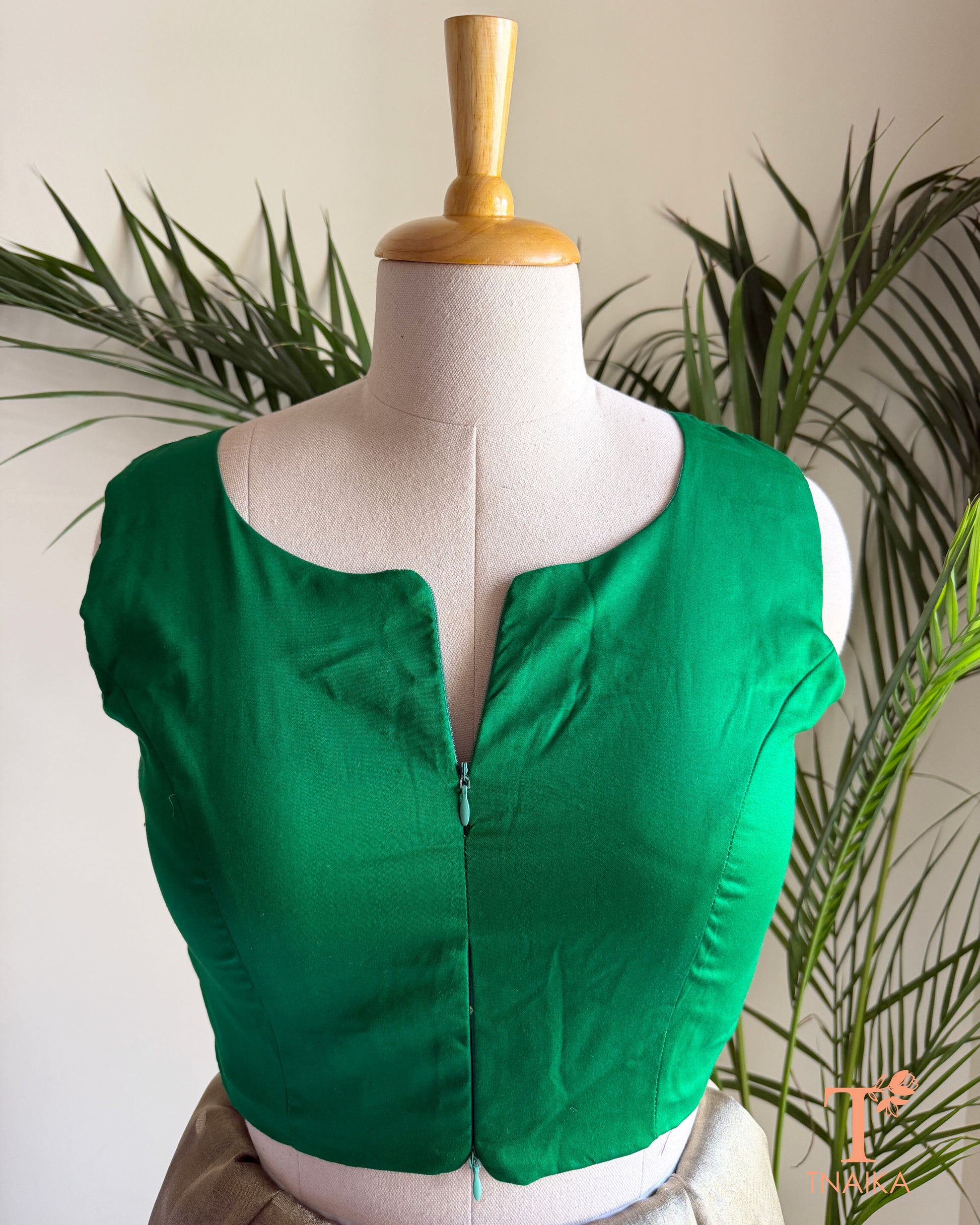 Front view of sleeveless silk blend saree blouse showcasing the innovative dual zipper opening from the top and bottom for an adjustable fit.