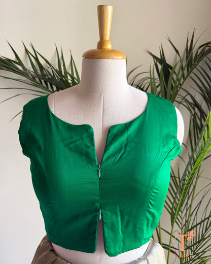 Emerald green silk blend sleeveless blouse featuring a modern notched round neckline and adjustable dual front zipper.