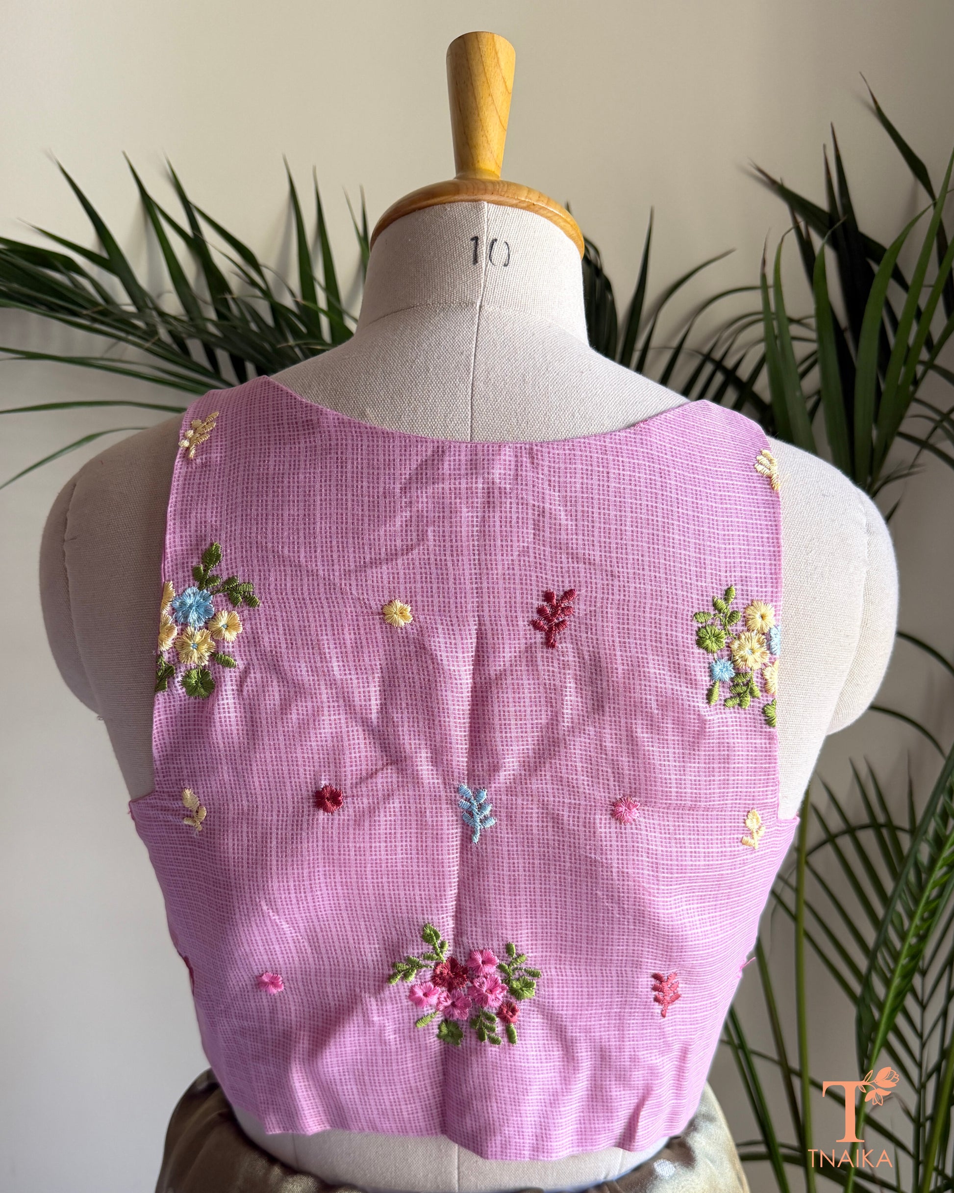 Back view of premium Kota silk blouse with delicate floral embroidery and elegant tailored finish.