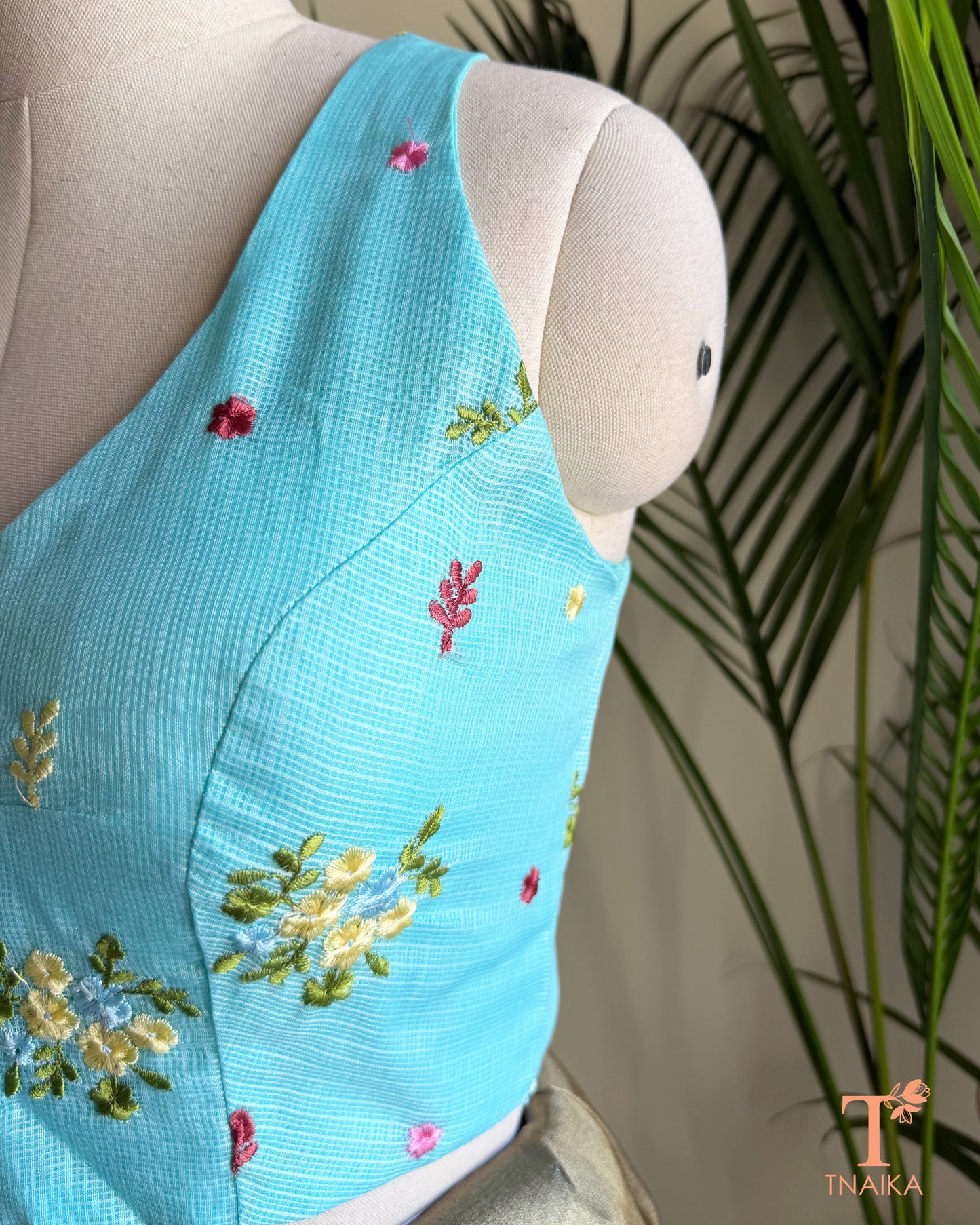 Designer Kota silk blouse with multicolour floral embroidery and elegant high-back silhouette for festive saree styling.