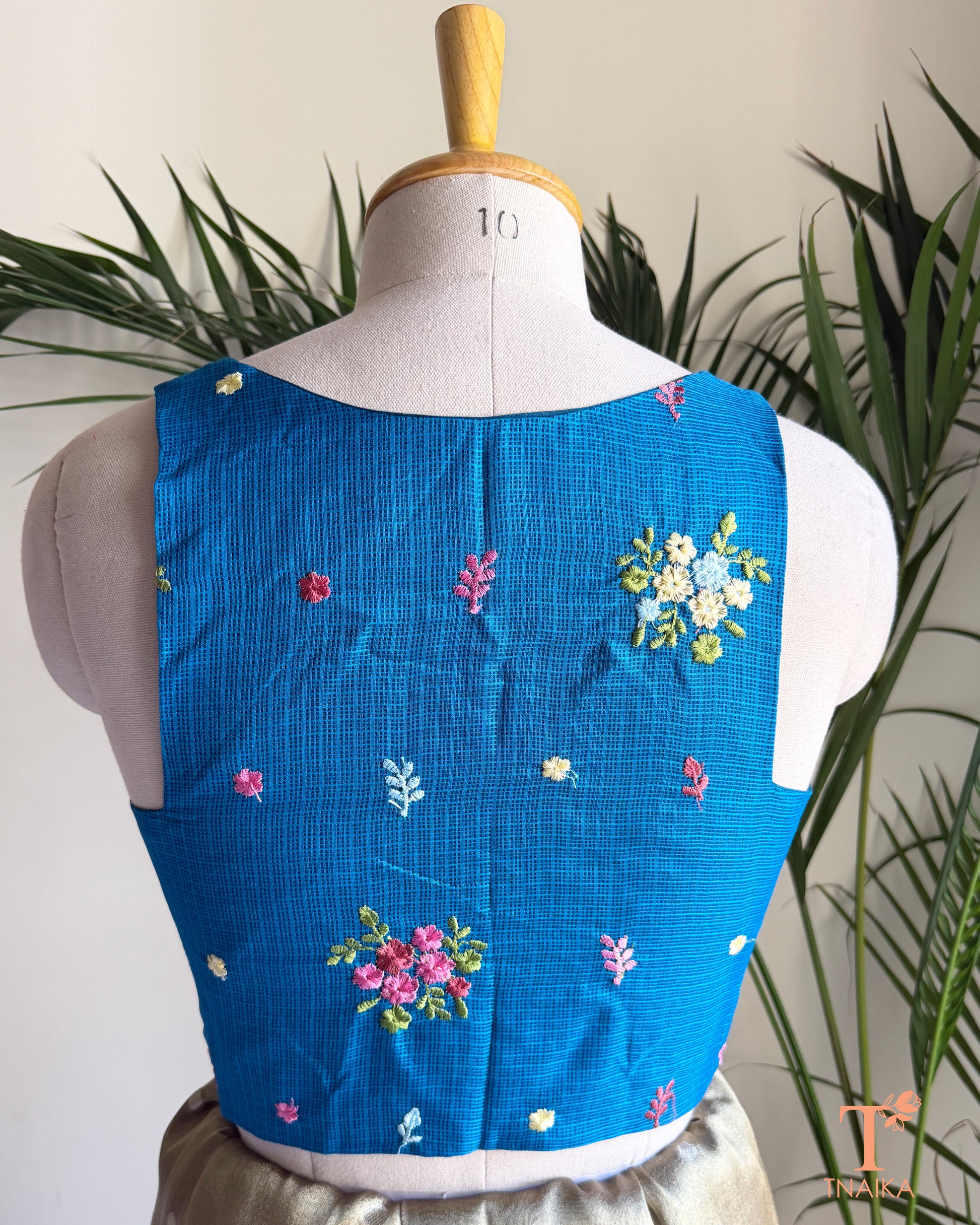 Back view of premium Kota silk blouse with delicate floral embroidery and elegant tailored finish.